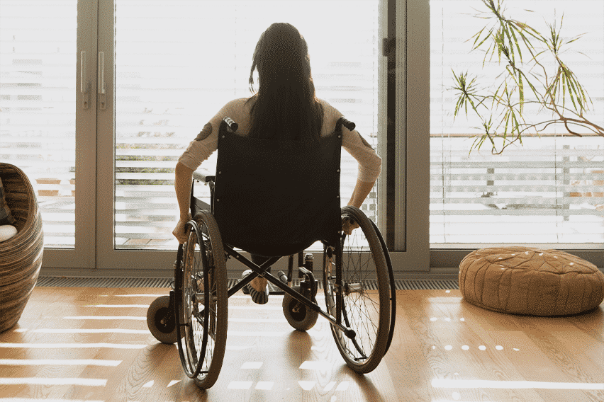 Photo looking at a woman in a wheelchair from the rear
